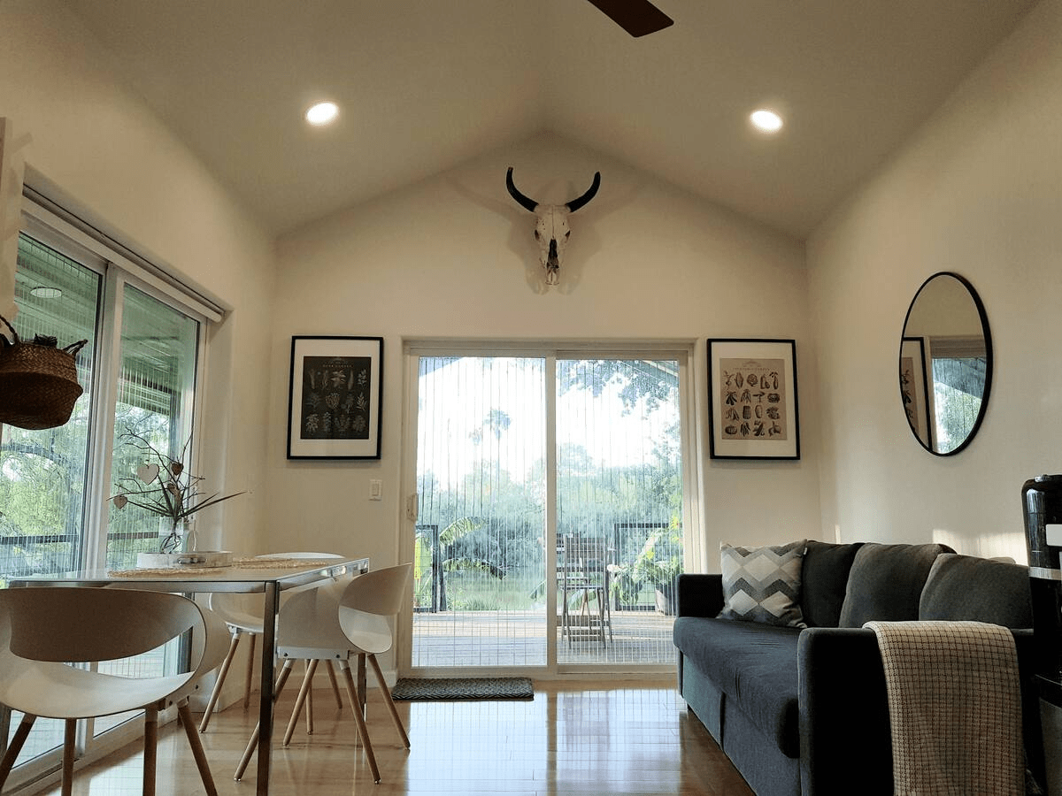 a well decorated cabin with a lot of windows for sunlight